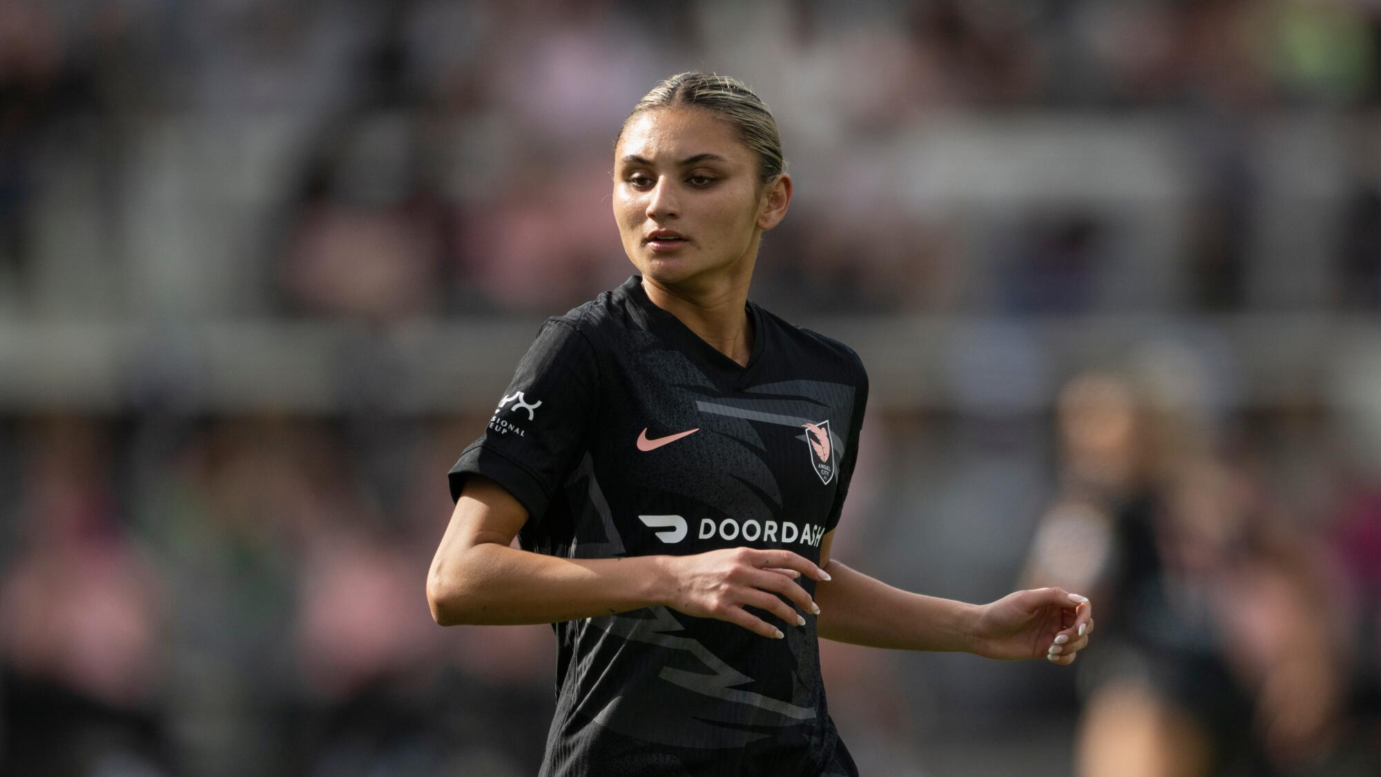 Angel City FC defender Gisele Thompson (20) runs during an NWSL soccer match.