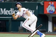 Texas Rangers batter Josh Smith watches his  fifth inning bunt shoot high in the air and...