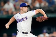 FILE - Texas Rangers relief pitcher David Robertson throws to the Pittsburgh Pirates in the...