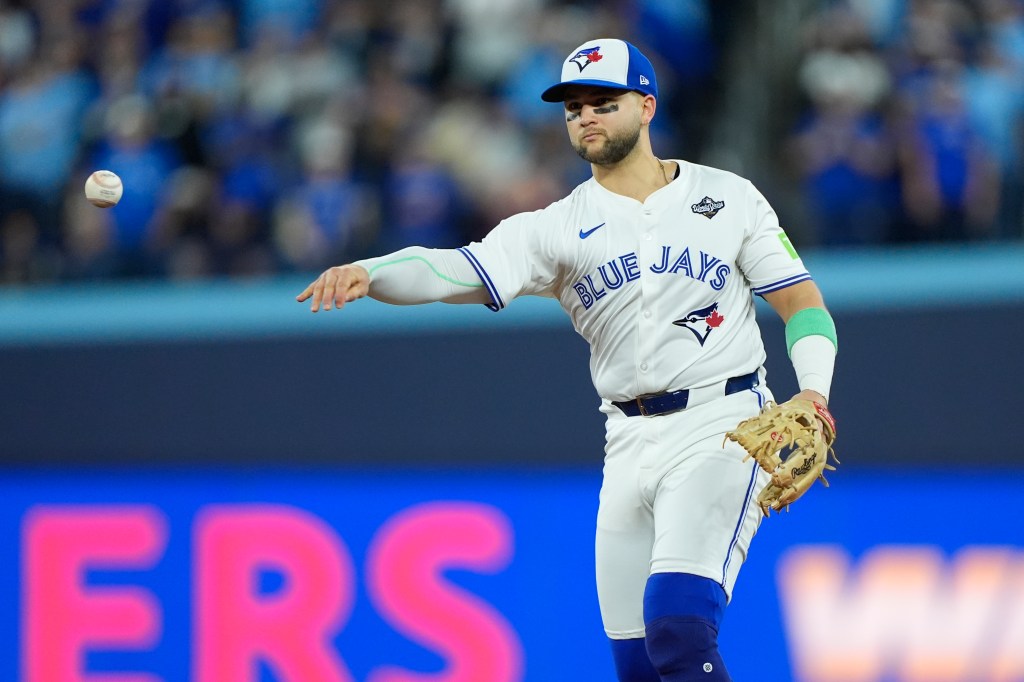 A Toronto Blue Jays player throwing a baseball during the World Series.