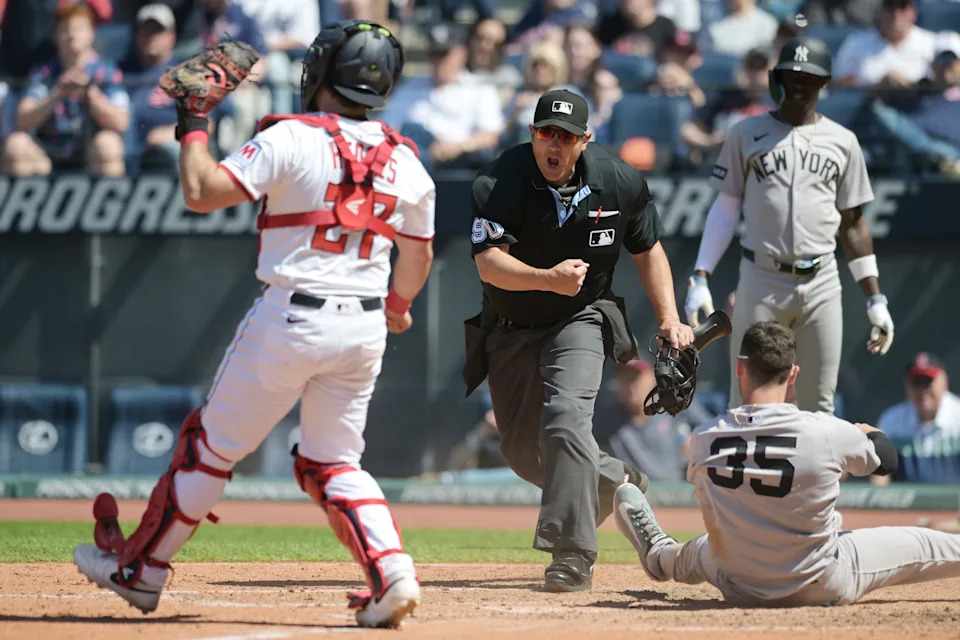 Home plate umpire Mark Ripperger makes the call after Cleveland Guardians catcher Austin Hedges (27) tagged out New York Yankees baserunner Cody Bellinger (35) on April 23, 2025, in Cleveland.