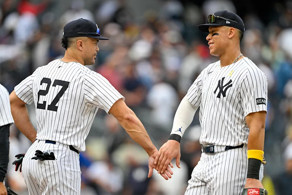 Sep 7, 2025; Bronx, New York, USA; New York Yankees designated hitter Giancarlo Stanton (27) celebrates with New York Yankees right fielder Aaron Judge (99) after the game against the Toronto Blue Jays at Yankee Stadium. Mandatory Credit: Mark Smith-Imagn Images