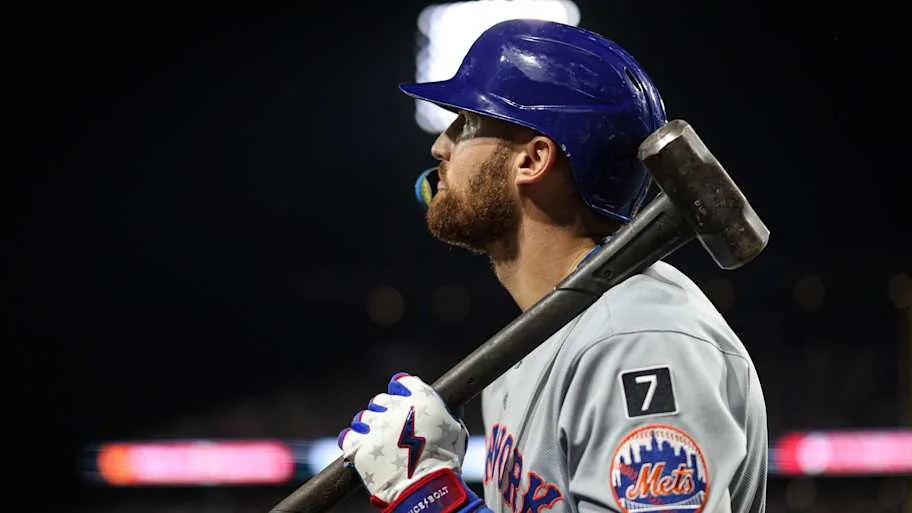 New York Mets outfielder Brandon Nimmo holds a sledgehammer in the on-deck circle.