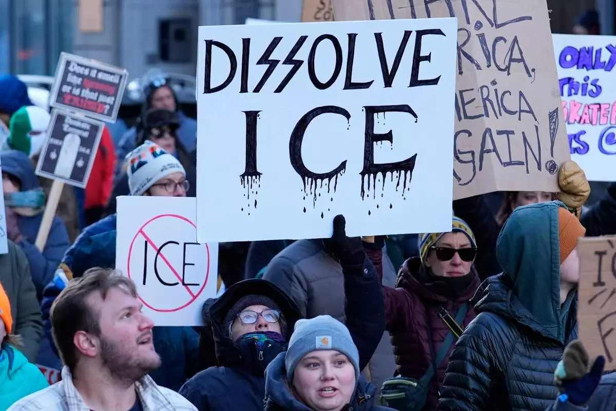 People protest against U.S. Immigrations and Customs enforcement in Portland, Maine, Friday, Jan. 30, 2026. (AP Photo/Robert F. Bukaty)