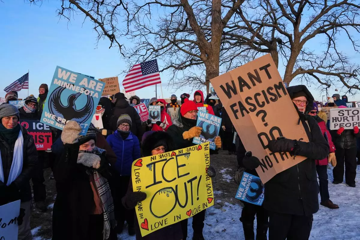 People gather for a protest outside the Bishop Henry Whipple Federal Building, Friday, Jan. 30, 2026, in Minneapolis. (AP Photo/Adam Gray)