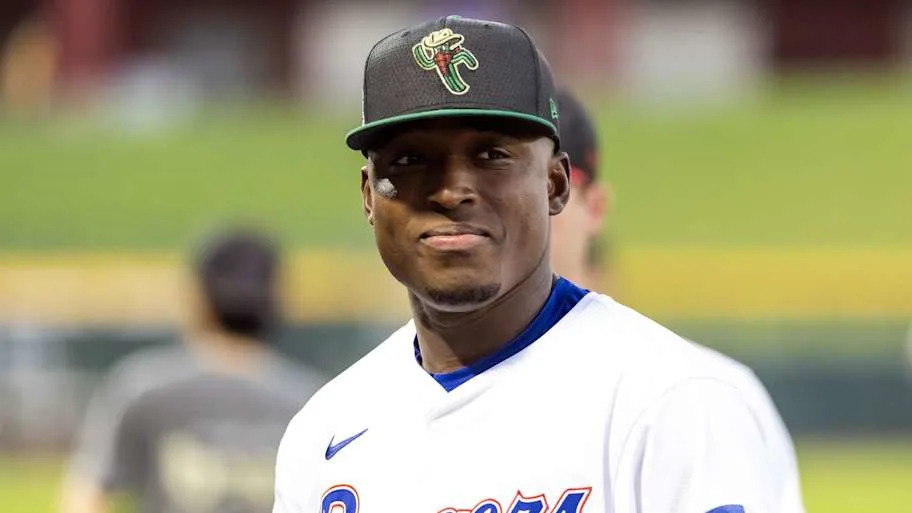 Texas Rangers pitcher Emiliano Teodo wearing a white jersey and black hat.