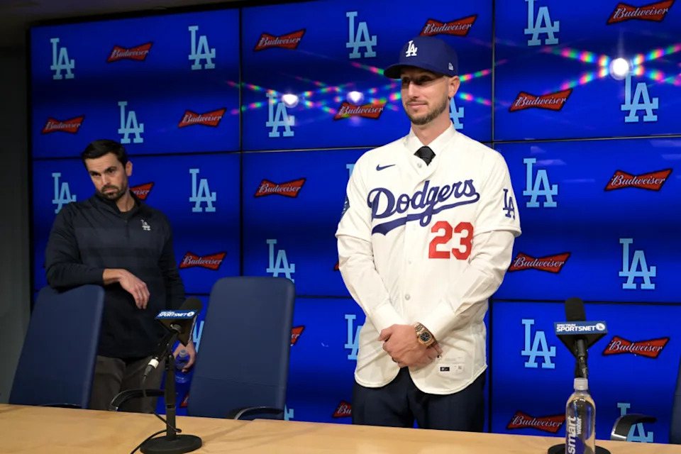Jan 21, 2026; Los Angeles, CA, USA; Los Angeles Dodgers general manager Brandon Gomes looks on as right fielder Kyle Tucker (23) is introduced to the media during a press conference at Dodger Stadium. Mandatory Credit: Jayne Kamin-Oncea-Imagn Images