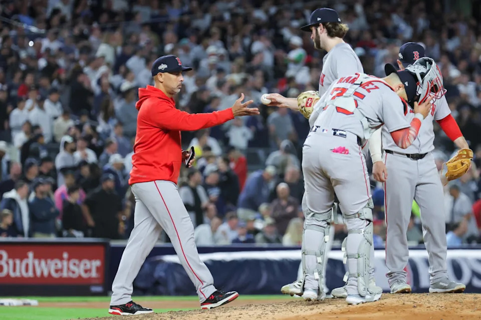 Oct 1, 2025; Bronx, New York, USA; Boston Red Sox manager Alex Cora (13) makes a pitching change during the fifth inning against the New York Yankees during game two of the Wildcard round for the 2025 MLB playoffs at Yankee Stadium. Mandatory Credit: Brad Penner-Imagn Images