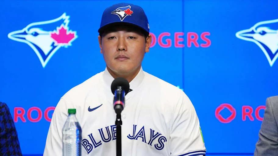 Toronto Blue Jays Kazuma Okamoto sitting in front of a microphone