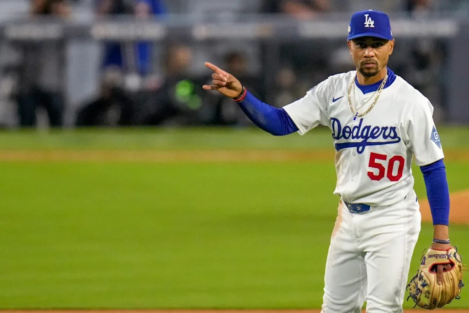 Los Angeles Dodgers shortstop Mookie Betts (50) signals two outs in the fourth inning of the MLB National League Wild Card Game 1 between the Los Angeles Dodgers and the Cincinnati Reds at Dodger Stadium in Los Angeles on Tuesday, Sept. 30, 2025. The Dodgers won game 1 of the series, 10-5.