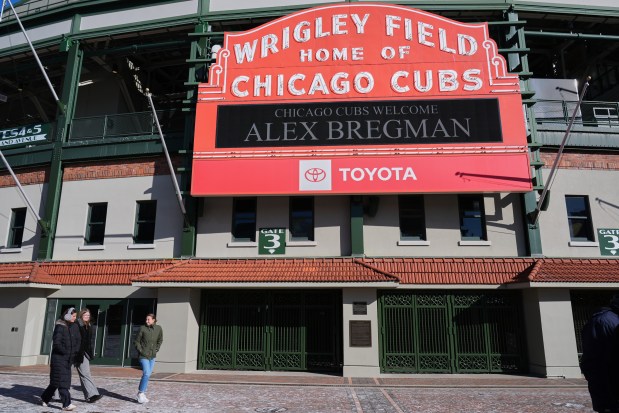 People walk by the front of Wrigley Field in Chicago, where the marquee displays the name of new Chicago Cubs infielder Alex Bregman Thursday, Jan. 15, 2026. (AP Photo/Nam Y. Huh)