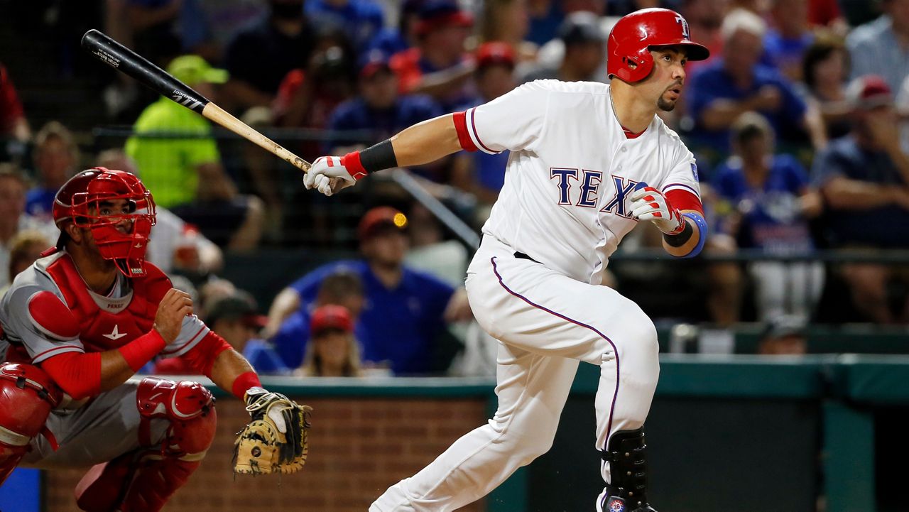 Texas Rangers' Carlos Beltran follows through on a two-run home run swing as Los Angeles Angels catcher Carlos Perez watches in the fifth inning of a baseball game, Sept. 21, 2016, in Arlington, Texas. (AP Photo/Tony Gutierrez, File)
