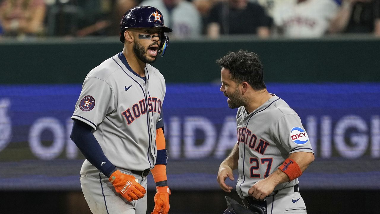Houston Astros' Carlos Correa, left, and Jose Altuve (27) celebrate after Correa hit a two-run home run that scored Altuve in the eighth inning of a baseball game against the Texas Rangers Friday, Sept. 5, 2025, in Arlington, Texas. (AP Photo/Tony Gutierrez)