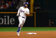 Texas Rangers shortstop Josh Smith (8) rounds second base after a solo home run during the...
