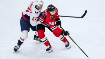 Dec 10, 2023; Chicago, Illinois, USA; Chicago Blackhawks center Connor Bedard (98) plays the puck as Washington Capitals defenseman Trevor van Riemsdyk (57) defends during the third period at the United Center. Daniel Bartel-USA TODAY Sports