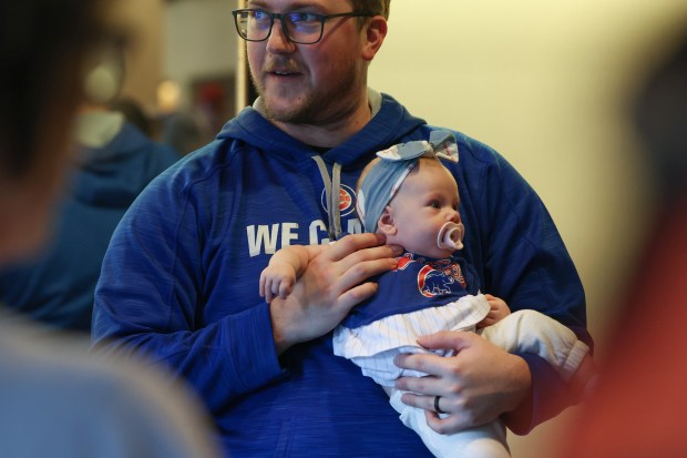 Jimmy Staab holds his three-month-old daughter, Bennett, while waiting in line to get autographs during the Cubs Convention at the Sheraton Grand Chicago Riverwalk on Jan. 17, 2025. (John J. Kim/Chicago Tribune)