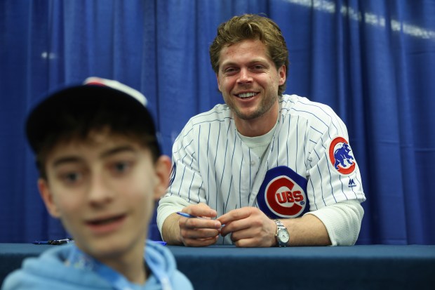 Cubs infielder Nico Hoerner takes a picture with a fan while signing autographs during the Cubs Convention at the Sheraton Grand Chicago Riverwalk on Jan. 17, 2025. (John J. Kim/Chicago Tribune)