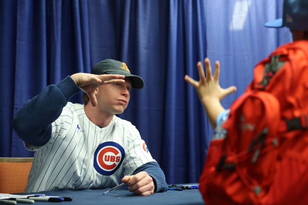 Cubs outfielder Pete Crow-Armstrong makes a fist bump explosion gesture with a fan while signing autographs during the Cubs Convention at the Sheraton Grand Chicago Riverwalk on Jan. 17, 2025. (John J. Kim/Chicago Tribune)