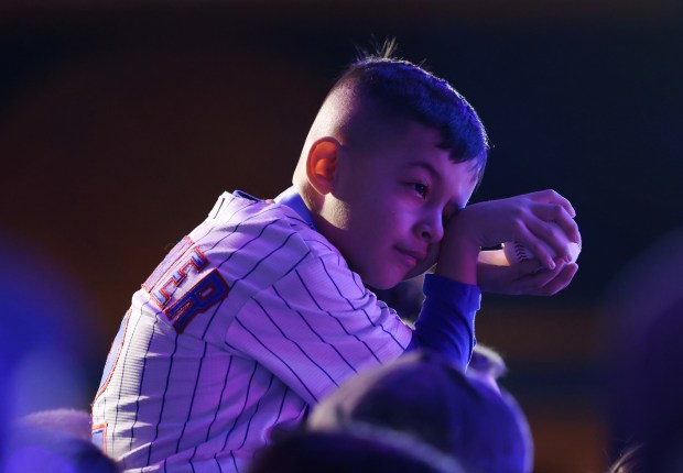 A young fan sits on a grown up's shoulders while waiting for a hopeful autograph from former Cubs infielder Anthony Rizzo during the Cubs Convention at the Sheraton Grand Chicago Riverwalk on Jan. 17, 2025. (John J. Kim/Chicago Tribune)