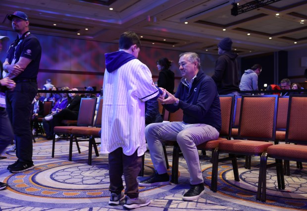 Cubs Chairman Tom Ricketts signs an autograph during the Cubs Convention at the Sheraton Grand Chicago Riverwalk on Jan. 17, 2025. (John J. Kim/Chicago Tribune)