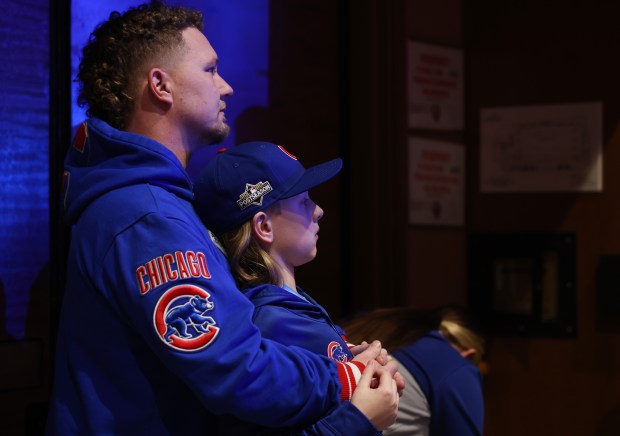 Gregory Dickinson and his son, Landen, 10, watch former Cubs players in a discussion about the 2016 World Series Champions team during the Cubs Convention at the Sheraton Grand Chicago Riverwalk on Jan. 17, 2025. (John J. Kim/Chicago Tribune)