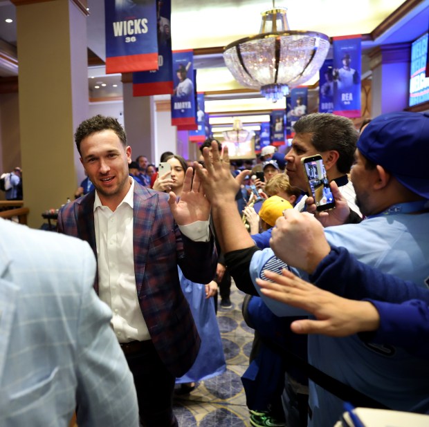 New Chicago Cubs player Alex Bregman high-fives fans while walking through the crowd during day 1 of the Cubs Convention at the Sheraton Grand Chicago on Friday, Jan. 16, 2026. (Chris Sweda/Chicago Tribune)