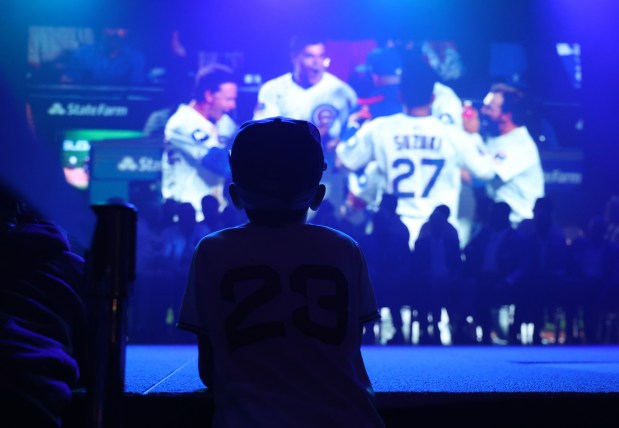 A young fan watches as a video tribute of the 2025 Chicago Cubs team is played during day 1 of the Cubs Convention at the Sheraton Grand Chicago on Friday, Jan. 16, 2026. (Chris Sweda/Chicago Tribune)