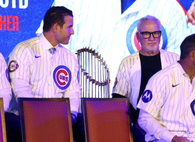 Former Chicago Cubs first baseman Anthony Rizzo (left) and former Cubs manager Joe Maddon sit on either side of their World Series trophy as the 2016 championship team is honored during day 1 of the Cubs Convention at the Sheraton Grand Chicago on Friday, Jan. 16, 2026. (Chris Sweda/Chicago Tribune)