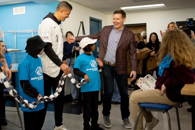 White Sox general manager Chris Getz, right, smiles before posing for a photo with manager Will Venable and kids during a community event Thursday, Jan. 29, 2026, at the Bartlett J. McCartin Boys & Girls Club in Bridgeport. (Josh Boland/Chicago Tribune)
