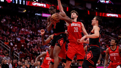 Mar 15, 2025; Houston, Texas, USA; Chicago Bulls forward Jalen Smith (7) rebounds against Houston Rockets center Alperen Sengun (28) during the third quarter at Toyota Center.