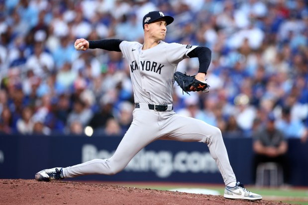 Luke Weaver #30 of the New York Yankees pitches against the Toronto Blue Jays during the seventh inning of game one of the Division Series at Rogers Centre on October 04, 2025 in Toronto, Ontario. 