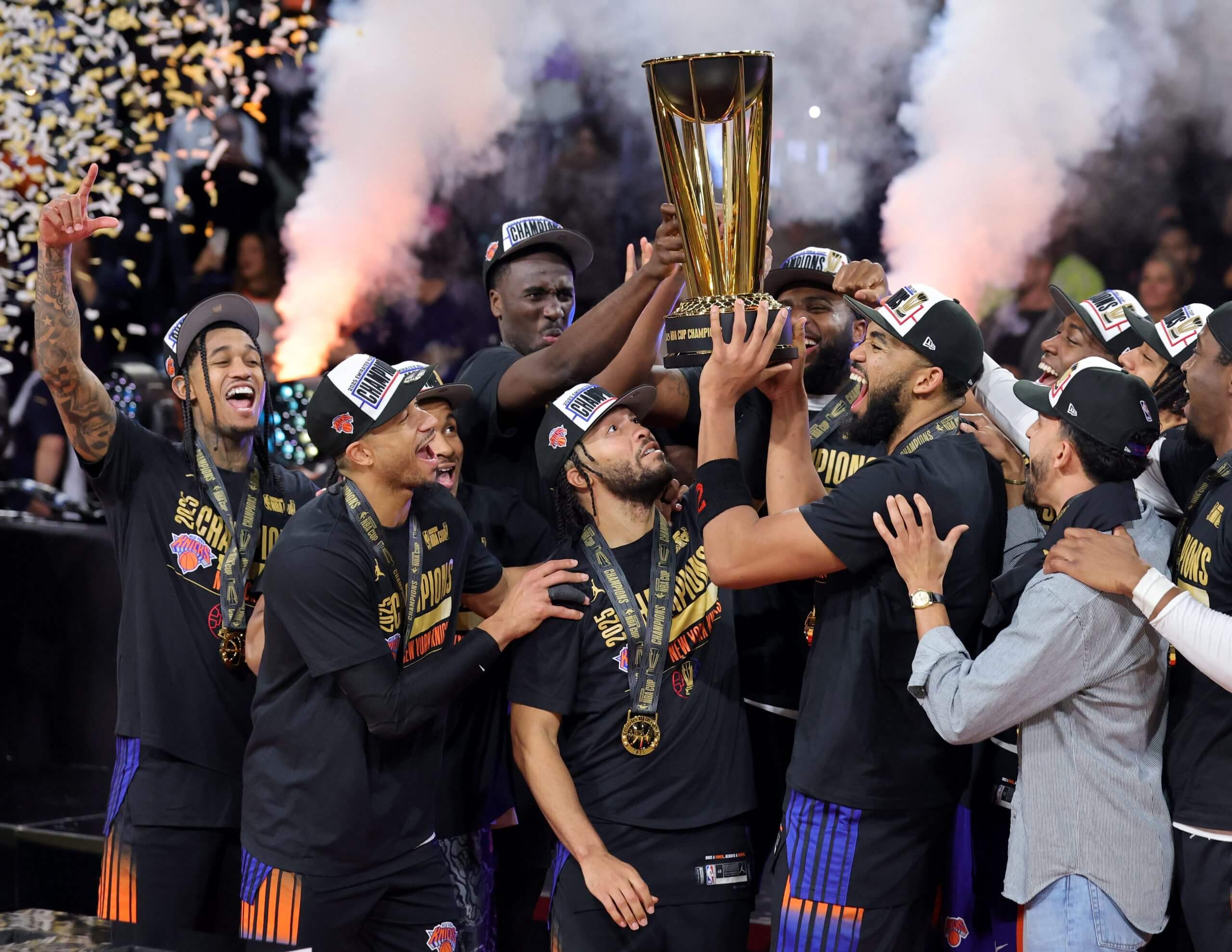 The New York Knicks hoist the NBA Cup, surrounded by smoke and confetti.