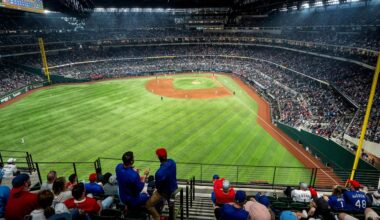 Fans watch an opening day baseball game between the Texas Rangers and the Philadelphia Phillies at Globe Life Field Thursday, March 30, 2023, in Arlington, Texas. (AP Photo/Jeffrey McWhorter)