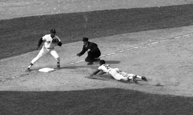 Lou Brock slides head first into third for his second stolen base in the same inning. The scene was the decisive seventh game of the 1967 World Series against the Boston Red Sox. St. Louis won. To quote the original photo caption: "Larcenous Lou set a Series record with seven swipes." (New York Daily News)