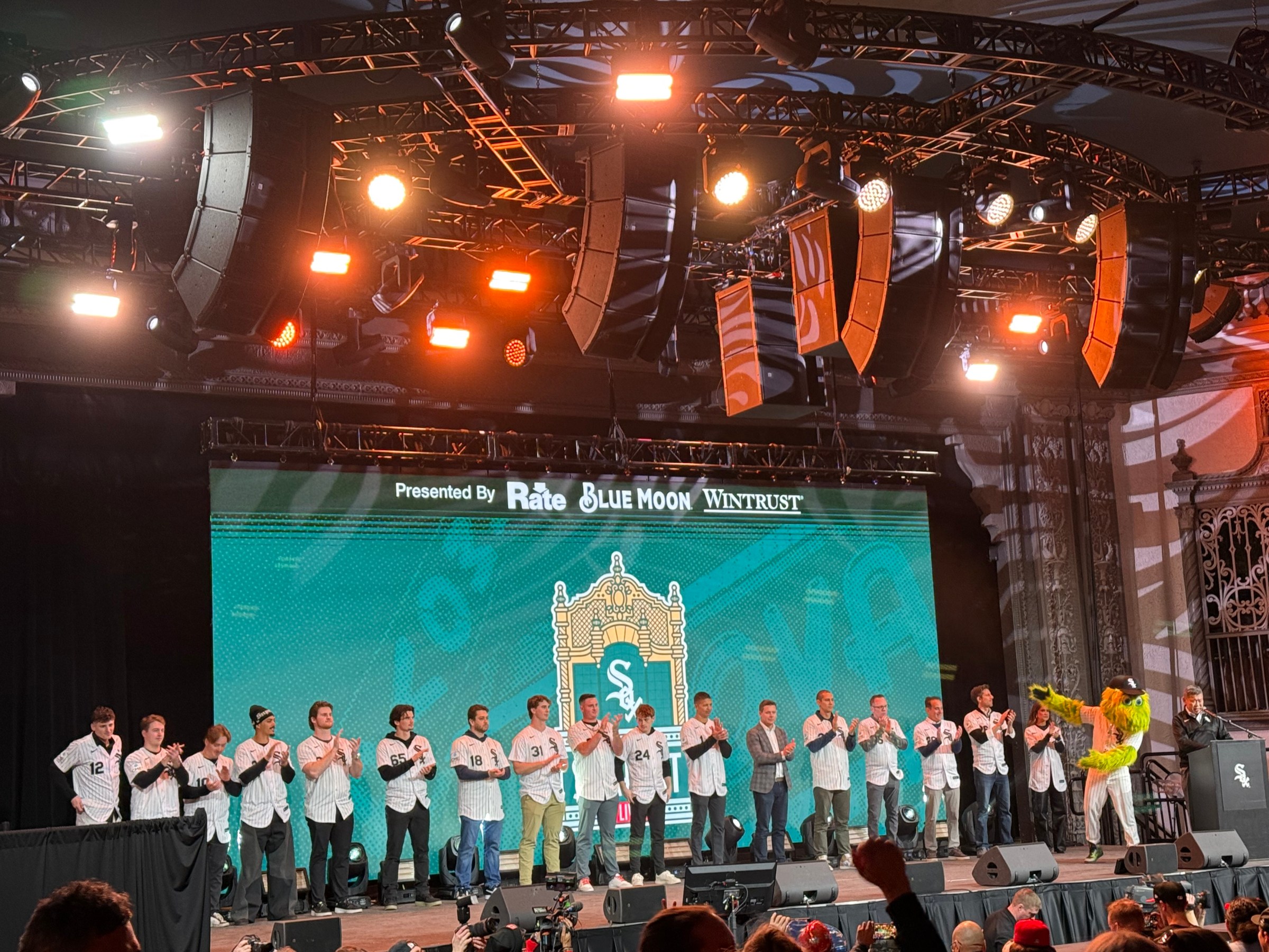 White Sox players and staff on the stage from left to right: Colson Montgomery, Kyle Teel, Chase Meidroth, Miguel Vargas, Shane Smith, Davis Martin, Anthony Kay, Grant Taylor, Tanner McDougal, Sam Antonacci, followed by Will Venable, Chris Getz, John Schriffen, Len Kasper, Chuck Garfein, Connor McKnight, and Brooke Fletcher