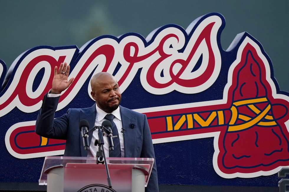 Former Atlanta Braves player, Andruw Jones waves to the crowd as he is honored, Saturday,...