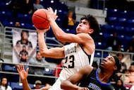 Mansfield forward Caden Shaver (23) goes strong to the basket against North Crowley guard...