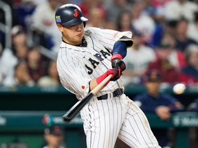 Japan's Kazuma Okamoto hits a home run during the fourth inning of the World Baseball Classic championship game against the United States, March 21, 2023, in Miami.