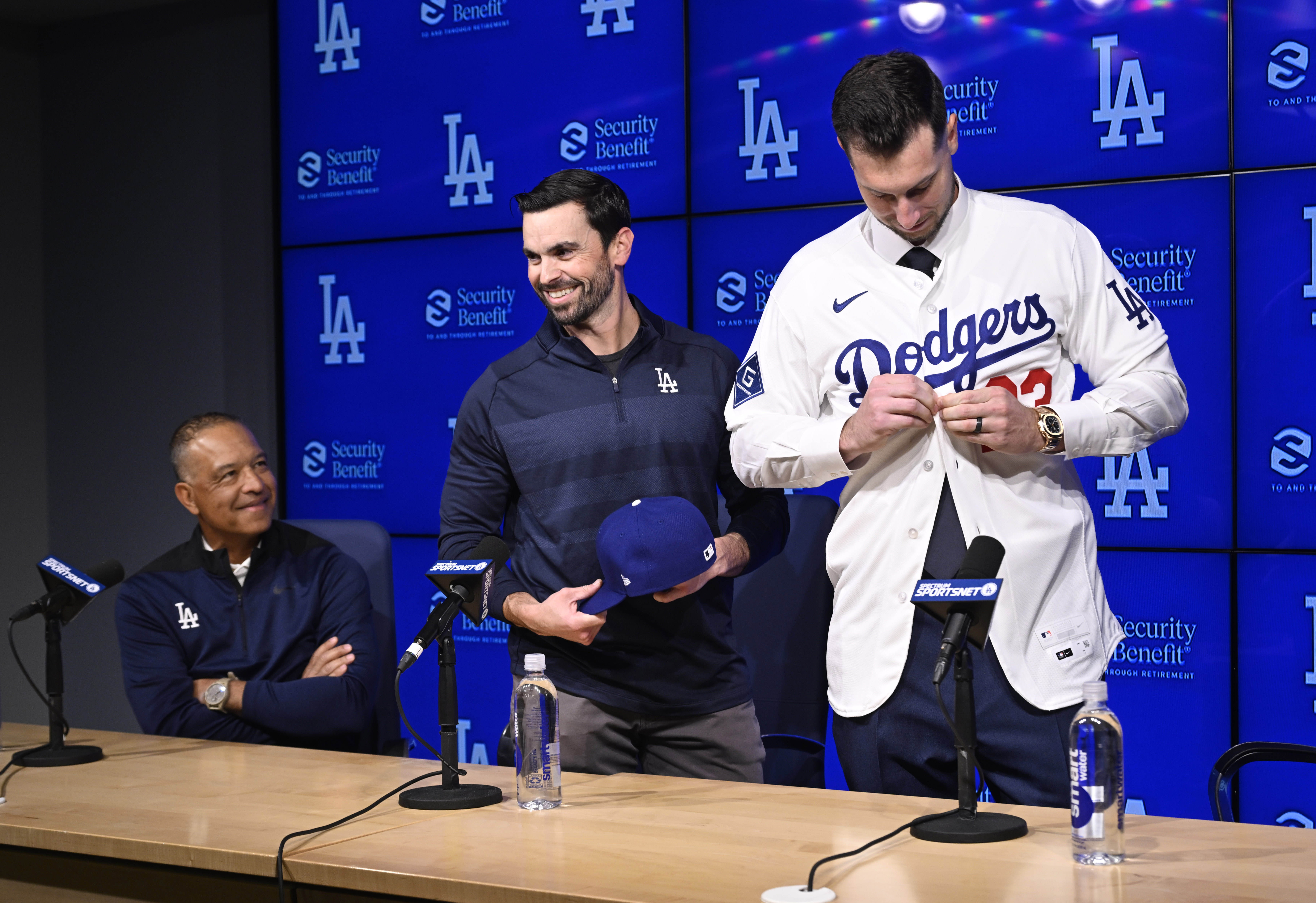 Dodgers general manager Brandon Gomes, center, helps newly signed outfielder...