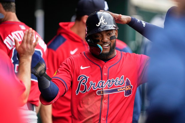 Atlanta Braves infielder Vidal Brujan celebrates in the dugout