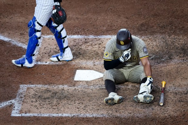 Xander Bogaerts #2 of the San Diego Padres sits on the ground after falling while batting against the Chicago Cubs during Game 3 of the NL Wild Card Series at Wrigley Field on Thursday, Oct. 2, 2025 in Chicago, Illinois. (Meg McLaughlin / The San Diego Union-Tribune)