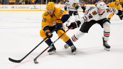 Jan 16, 2025; Nashville, Tennessee, USA; Nashville Predators defenseman Justin Barron (20) and Chicago Blackhawks defenseman Alex Vlasic (72) during the third period at Bridgestone Arena. Mandatory Credit: Steve Roberts-Imagn Images