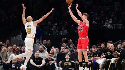 Jan 5, 2026; Boston, Massachusetts, USA; Chicago Bulls guard Kevin Huerter (13) shoots the ball over Boston Celtics guard Derrick White (9) during the first half at TD Garden.