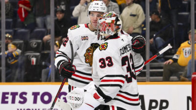 Jan 10, 2026; Nashville, Tennessee, USA; Chicago Blackhawks goaltender Drew Commesso (33) celebrates the win with defenseman Alex Vlasic (72) against the Nashville Predators during the third period at Bridgestone Arena. Mandatory Credit: Steve Roberts-Imagn Images