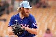 Texas Rangers pitcher Zak Kent delivers during the third inning of a spring training game...