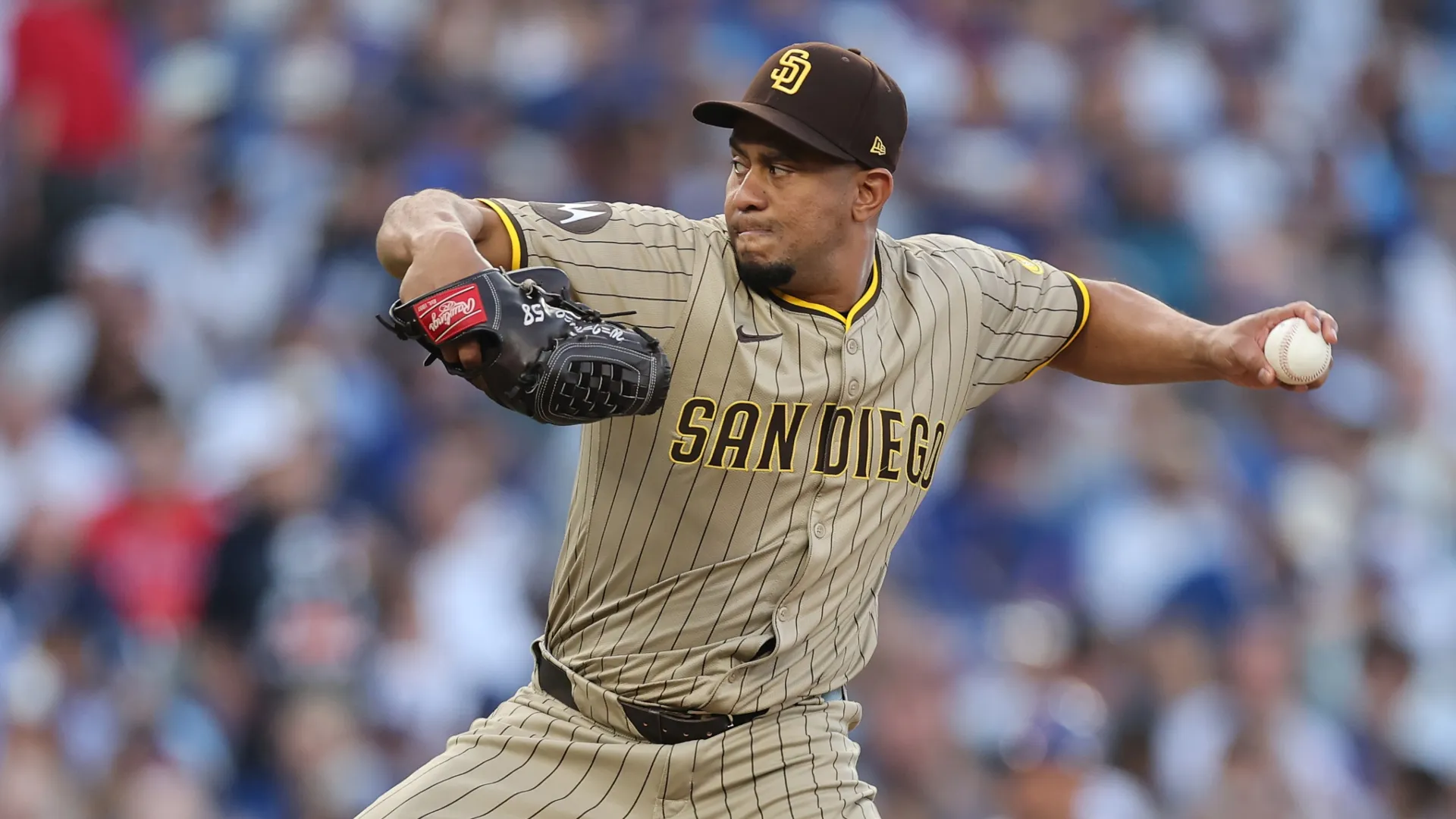 Wandy Peralta #58 of the Padres throws a pitch in the fifth inning against the Cubs. Michael Reaves/Getty Images