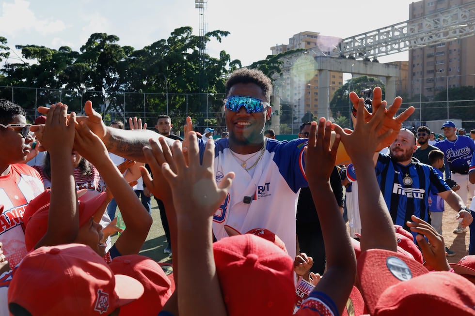 Atlanta Braves' Ronald Acuña Jr. high fives young participants during a baseball clinic at the...