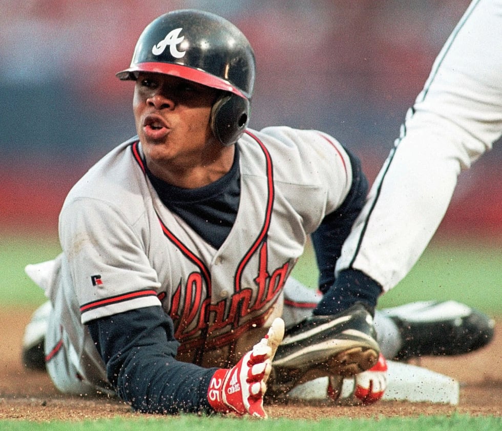 Atlanta Braves Andruw Jones slides safely into third base in the fourth inning against the...