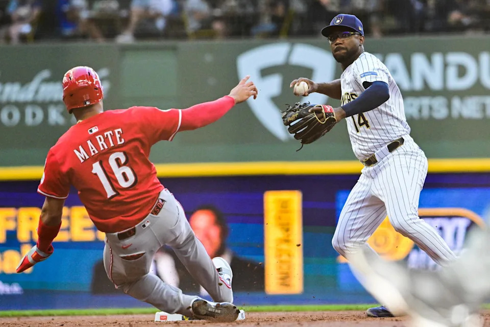 Cincinnati Reds outfielder Noelvi Marte (16) and Milwaukee Brewers shortstop Andruw Monasterio (14). © Benny Sieu-Imagn Images