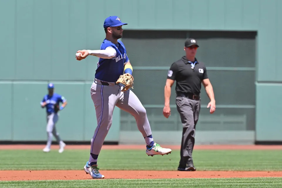 Jun 29, 2025; Boston, Massachusetts, USA; Toronto Blue Jays shortstop Bo Bichette (11) throws the ball to first base for an out against the Boston Red Sox during the first inning at Fenway Park. (Eric Canha/Imagn Images)